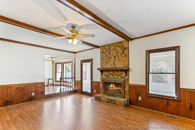 a view of livingroom with furniture fireplace and window