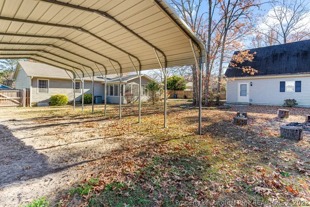 a backyard of a house with barbeque oven table and chairs