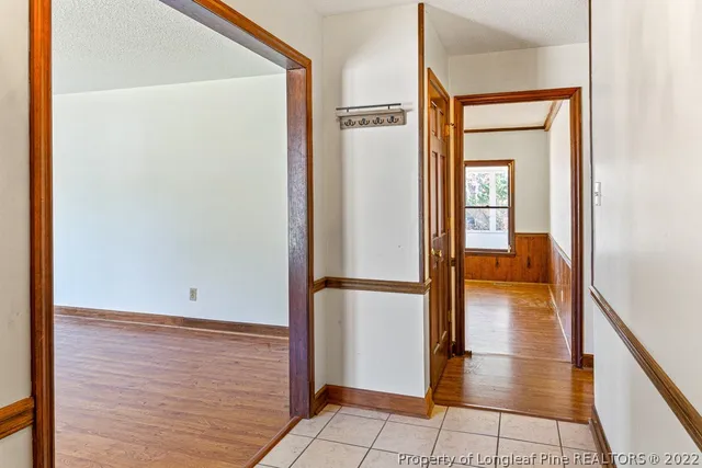 a view of a hallway with wooden floor and entryway