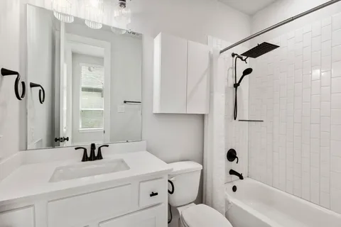 a bathroom with a sink a toilet and a bathtub