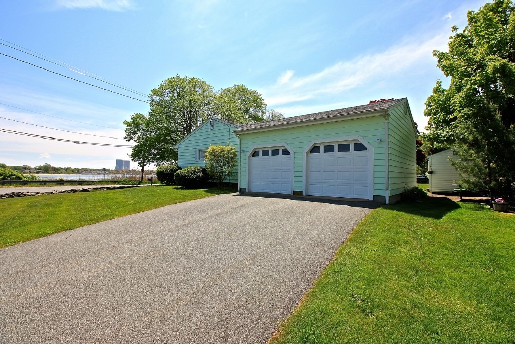 821 Pearse Road Swansea, MA 02777 - Photo 2 of 7 a view of a house with a yard and garage