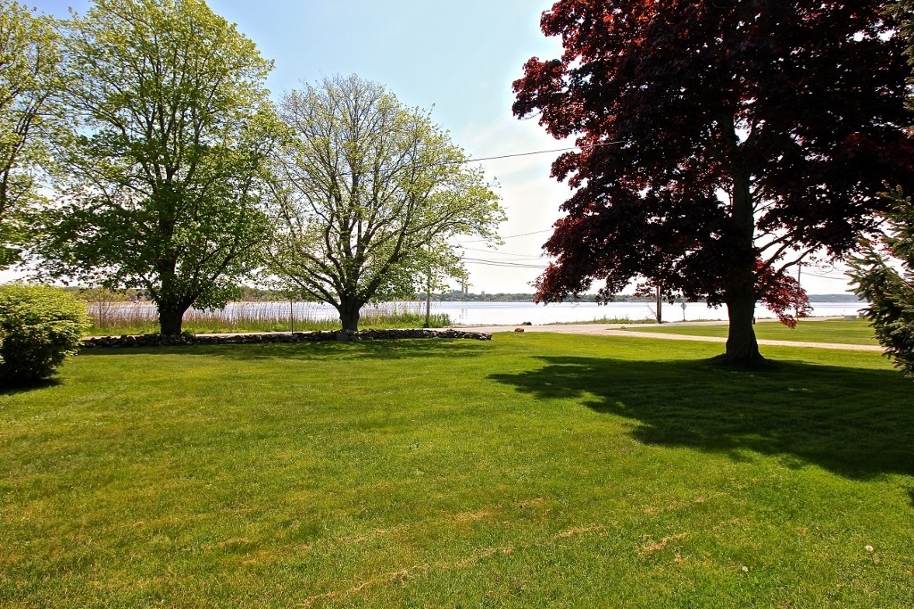 821 Pearse Road Swansea, MA 02777 - Photo 5 of 7 a view of grassy field with benches and trees