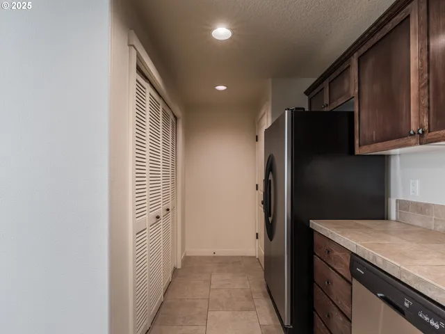 a kitchen with a refrigerator and a stove top oven