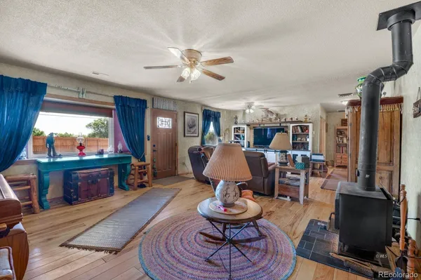 a living room with furniture a piano and a flat screen tv