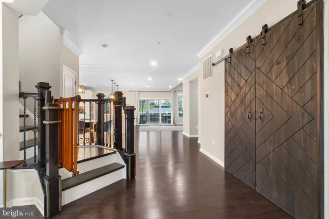 a kitchen with stainless steel appliances kitchen island granite countertop a sink a stove and a wooden floors