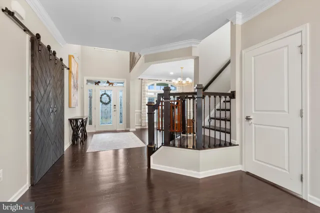 a kitchen with stainless steel appliances granite countertop a stove top oven a refrigerator a sink dishwasher a dining table and chairs with wooden floor