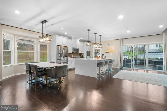 a living room with furniture a fireplace and a large window