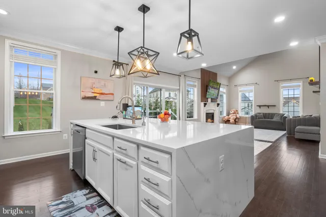 a spacious bedroom with a bed and a chandelier