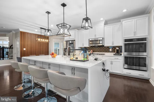 a spacious bedroom with a large bed and a chandelier
