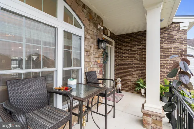 a living room with furniture and a dining table with wooden floor