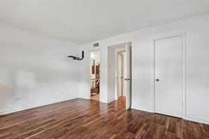 15914 Club Crest Drive, Unit 1112 Dallas, TX 75248 - Photo 19 of 35 a view of an empty room with wooden floor