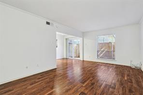 15914 Club Crest Drive, Unit 1112 Dallas, TX 75248 - Photo 28 of 35 a view of an empty room with wooden floor and a window