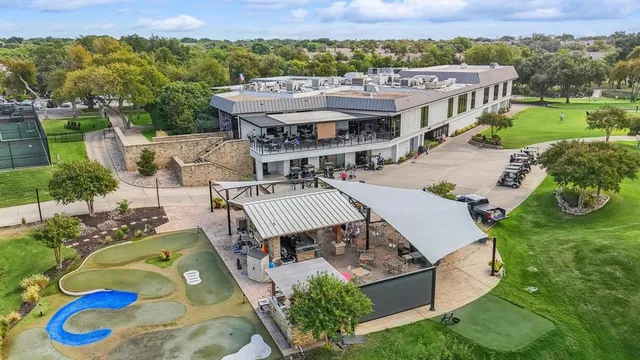 an aerial view of a golf course with parking space