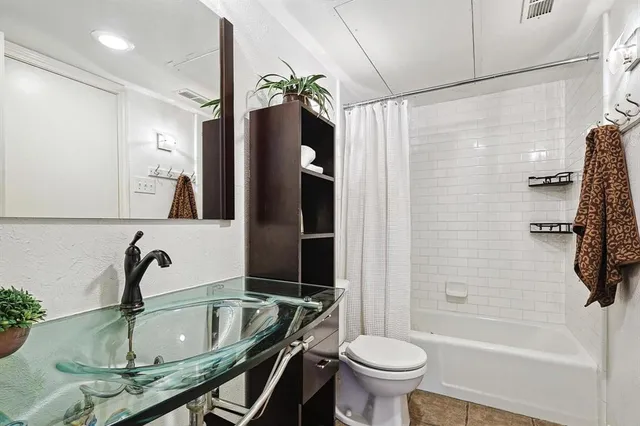 a kitchen with granite countertop a sink stove and cabinets