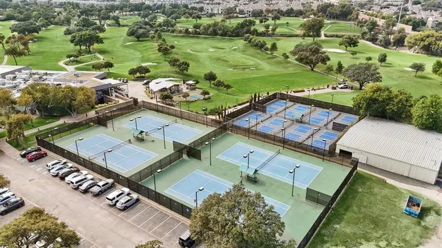an aerial view of residential houses with outdoor space and street view