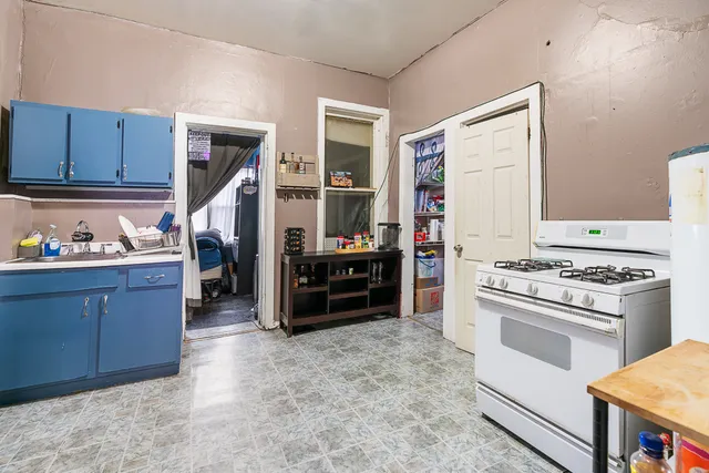 a kitchen with wooden cabinets and a stove top oven