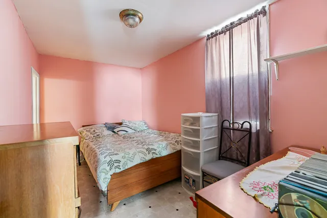 a bedroom with a bed and a table in it