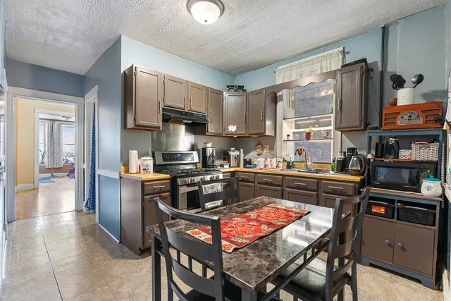 a kitchen with stainless steel appliances granite countertop a stove top oven a sink dishwasher and cabinets