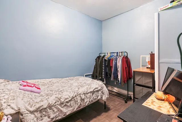 a bedroom with a bed and a desk