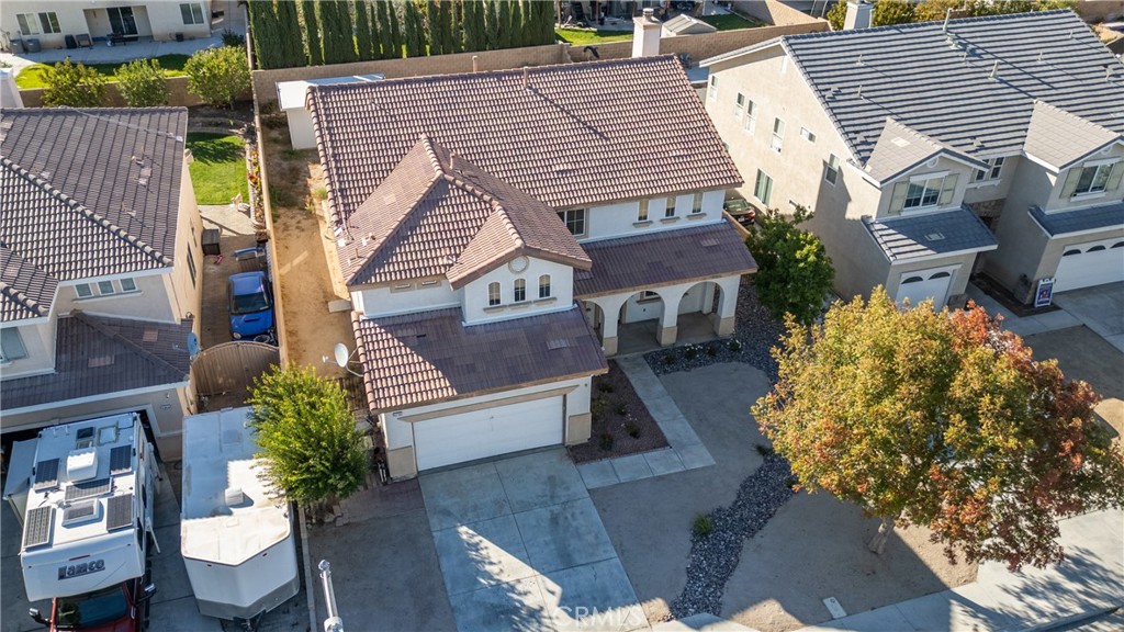 43705 46th Street West Lancaster, CA 93536 - Photo 4 of 4 a view of a house with a chairs in patio