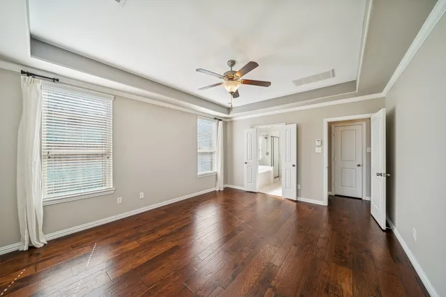 a living room with furniture a flat screen tv and a window