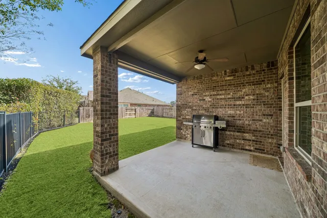 an aerial view of a house with a big yard