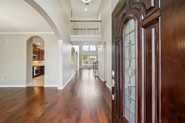 a kitchen with stainless steel appliances kitchen island granite countertop a table chairs sink and cabinets