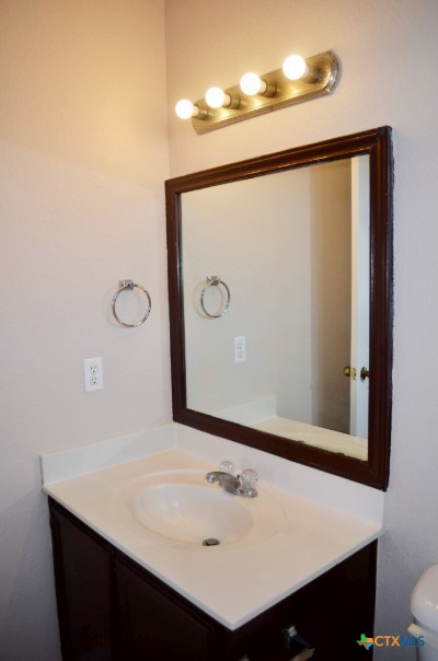 5406 Oster Drive Killeen, TX 76542 - Photo 12 of 46 a bathroom with a sink and a mirror