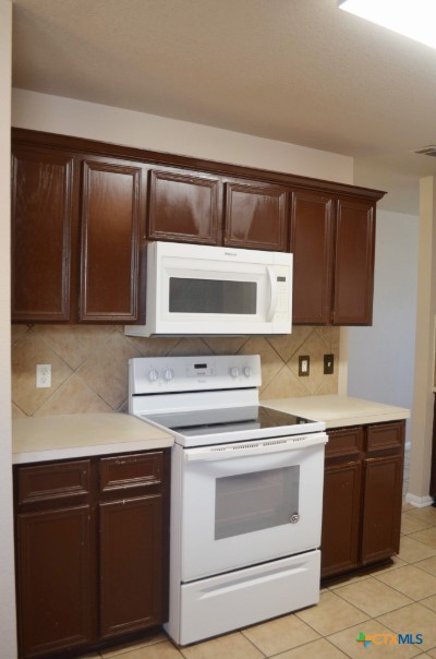 5406 Oster Drive Killeen, TX 76542 - Photo 14 of 46 a kitchen with a sink stove and microwave
