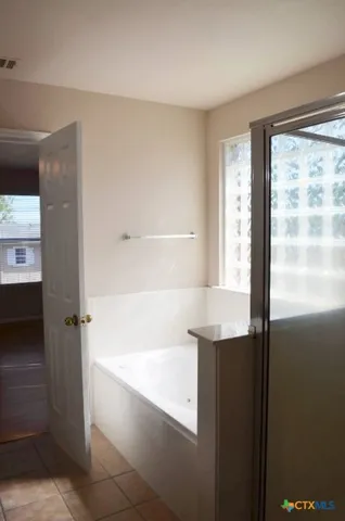 a view of a livingroom with a ceiling fan window and wooden floor