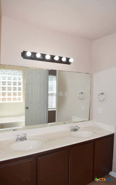 5406 Oster Drive Killeen, TX 76542 - Photo 20 of 46 a bathroom with a double vanity sink and mirror
