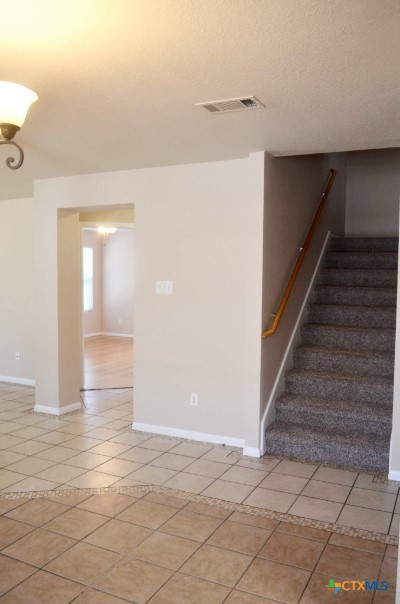 5406 Oster Drive Killeen, TX 76542 - Photo 35 of 46 a view of a hallway with wooden floor and staircase