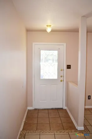 a view of an empty room and a window