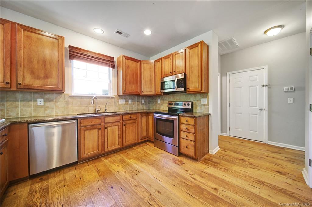 332 Sand Paver Way Fort Mill, SC 29708 - Photo 22 of 43 a kitchen with stainless steel appliances granite countertop a stove a sink and a refrigerator