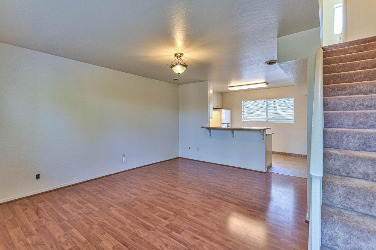 830 Parcel Street Monterey, CA 93940 - Photo 2 of 18 wooden floor in an empty room with a window