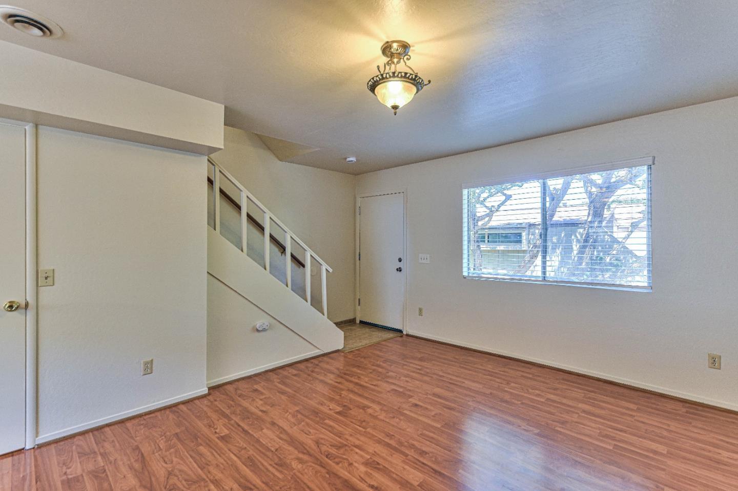 830 Parcel Street Monterey, CA 93940 - Photo 3 of 18 a view of an empty room with a window and wooden floor