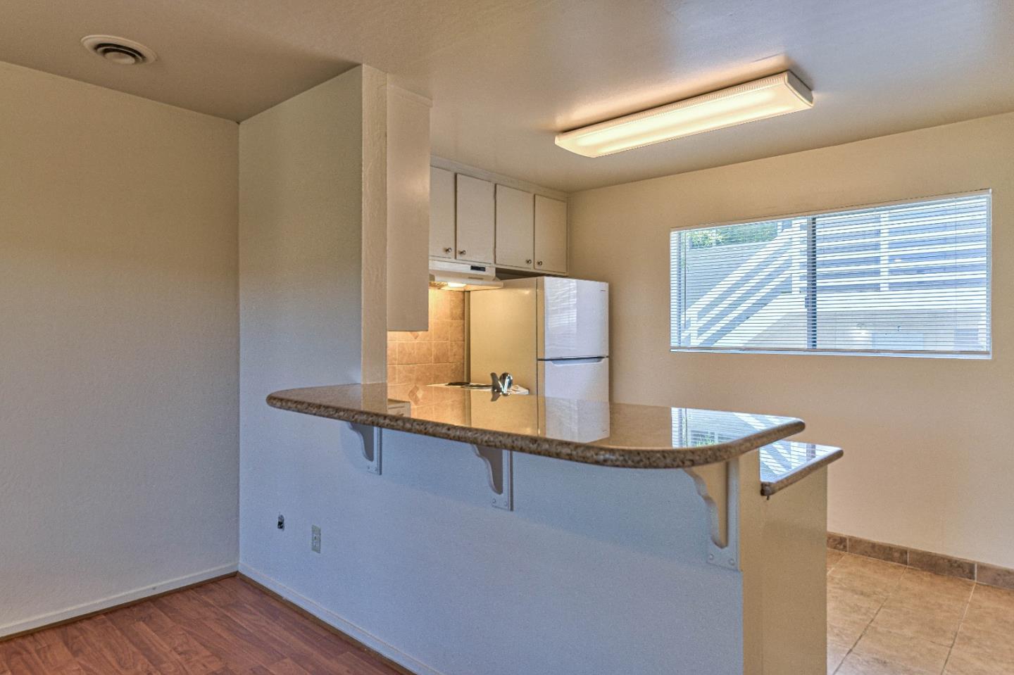 830 Parcel Street Monterey, CA 93940 - Photo 6 of 18 a room with table chairs and wooden floor