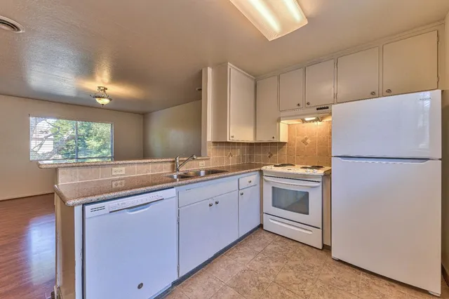 a kitchen with a white cabinets and refrigerator