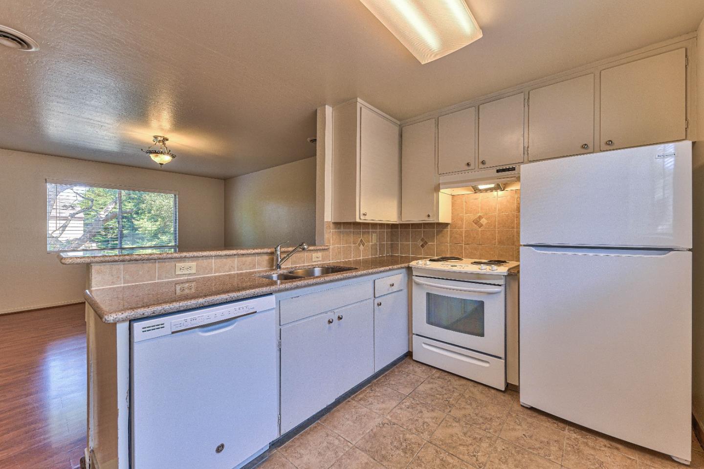 830 Parcel Street Monterey, CA 93940 - Photo 7 of 18 a kitchen with a white cabinets and refrigerator