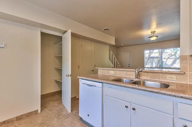 a kitchen with a sink and a window