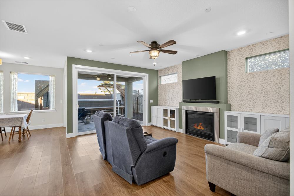 12086 Mircado Way Rancho Cordova, CA 95742 - Photo 13 of 84 a living room with furniture a fireplace and a flat screen tv
