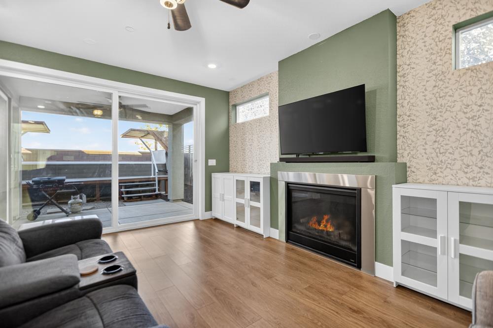12086 Mircado Way Rancho Cordova, CA 95742 - Photo 14 of 84 a living room with furniture a flat screen tv and a fireplace