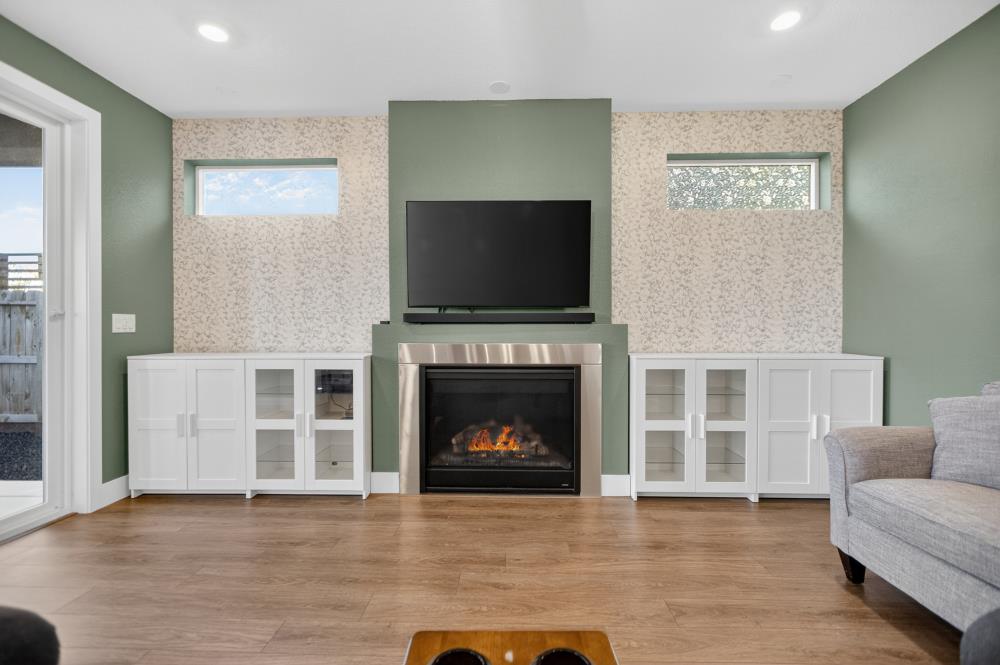 12086 Mircado Way Rancho Cordova, CA 95742 - Photo 15 of 84 a living room with furniture a flat screen tv and a fireplace