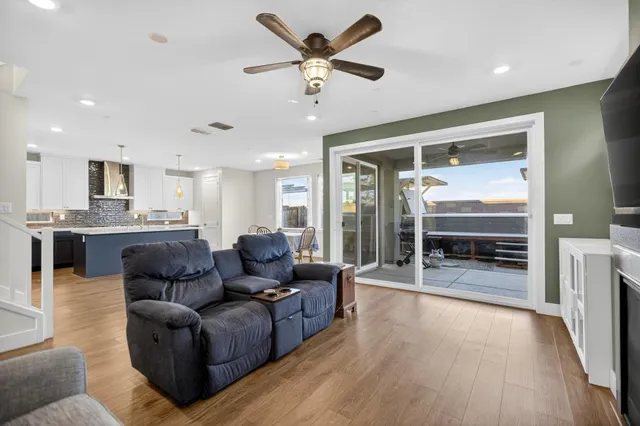 a kitchen with stainless steel appliances granite countertop a sink a stove and a wooden floors