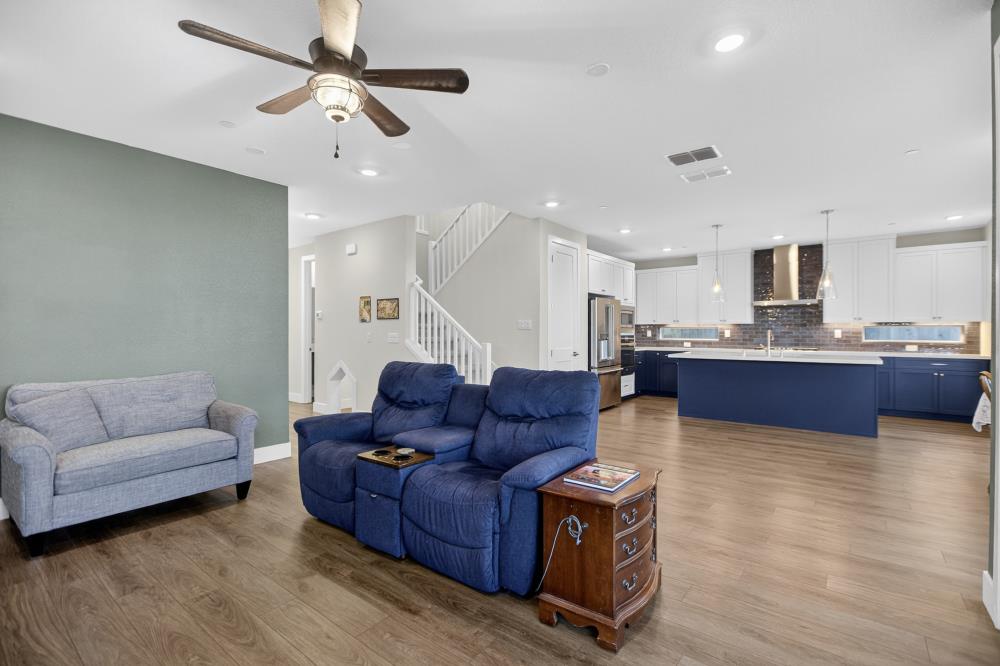 12086 Mircado Way Rancho Cordova, CA 95742 - Photo 17 of 84 a living room with couches and kitchen view with wooden floor