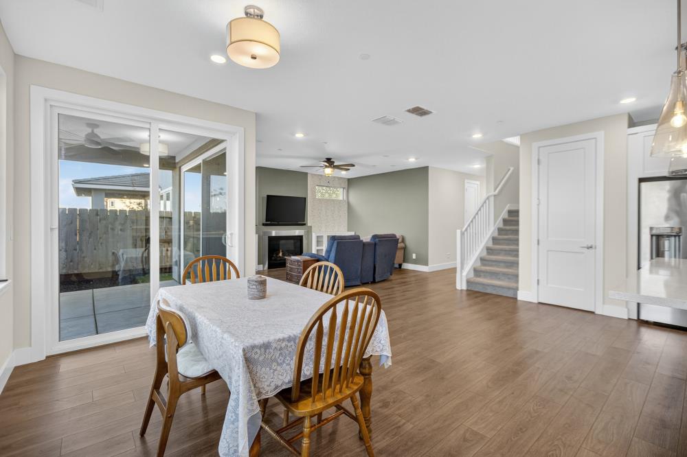 12086 Mircado Way Rancho Cordova, CA 95742 - Photo 27 of 84 a view of a dining room with furniture and wooden floor
