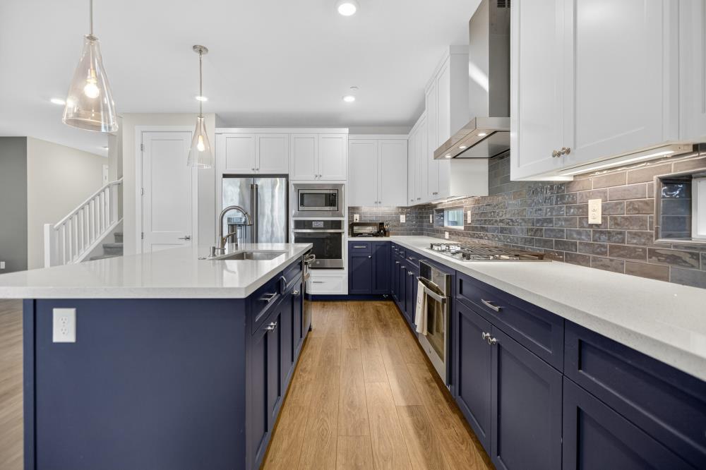12086 Mircado Way Rancho Cordova, CA 95742 - Photo 31 of 84 a kitchen with kitchen island granite countertop a sink a counter top space stainless steel appliances and cabinets