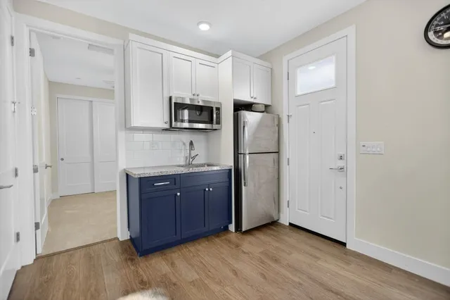 a spacious bathroom with a double vanity sink toilet mirror and bathtub
