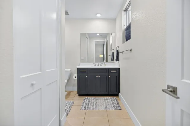 a bathroom with double vanity sinks and a mirror