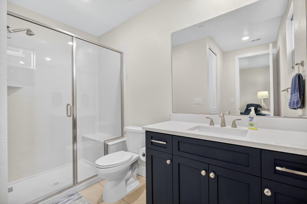 12086 Mircado Way Rancho Cordova, CA 95742 - Photo 41 of 84 a bathroom with a toilet a sink a mirror a vanity and shower